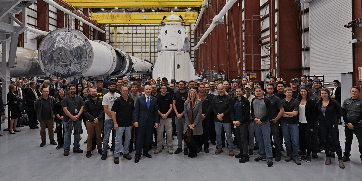 SpaceX team, Crew Dragon and Falcon 9 inside the production hangar.