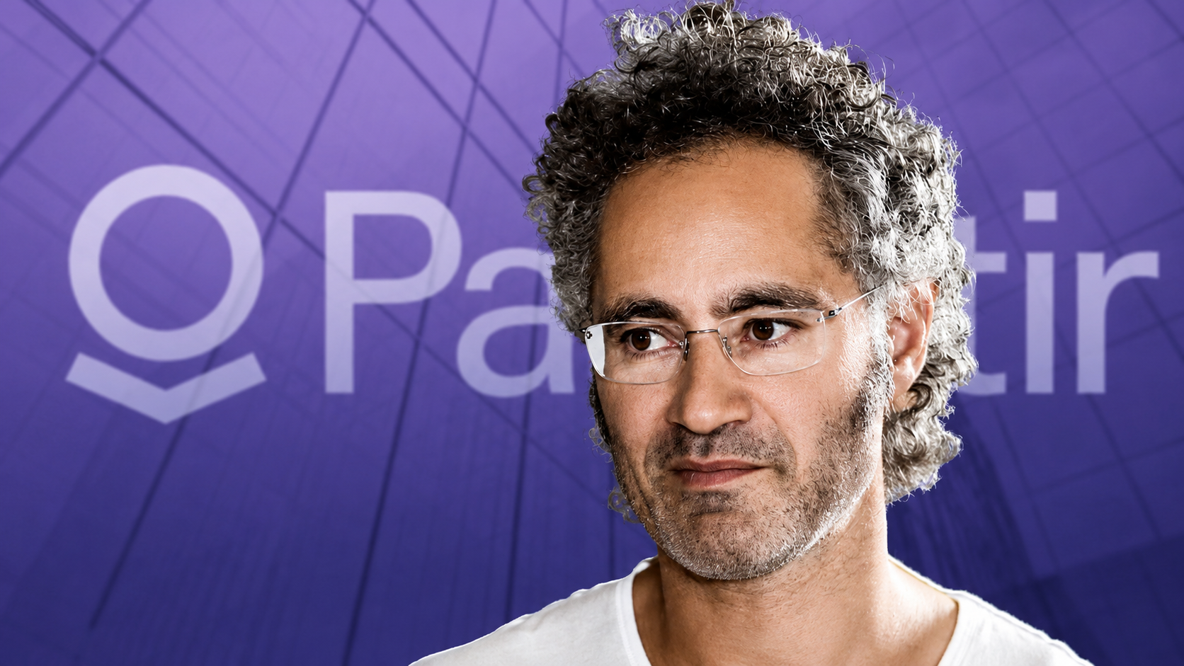Alex Karp, co-founder and CEO of Palantir Technologies, in front of the company logo.