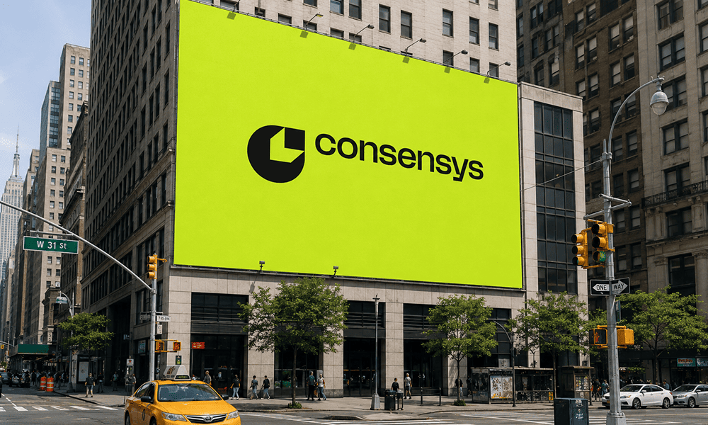 A billboard featuring the Consensys logo on the facade of a building in New York
